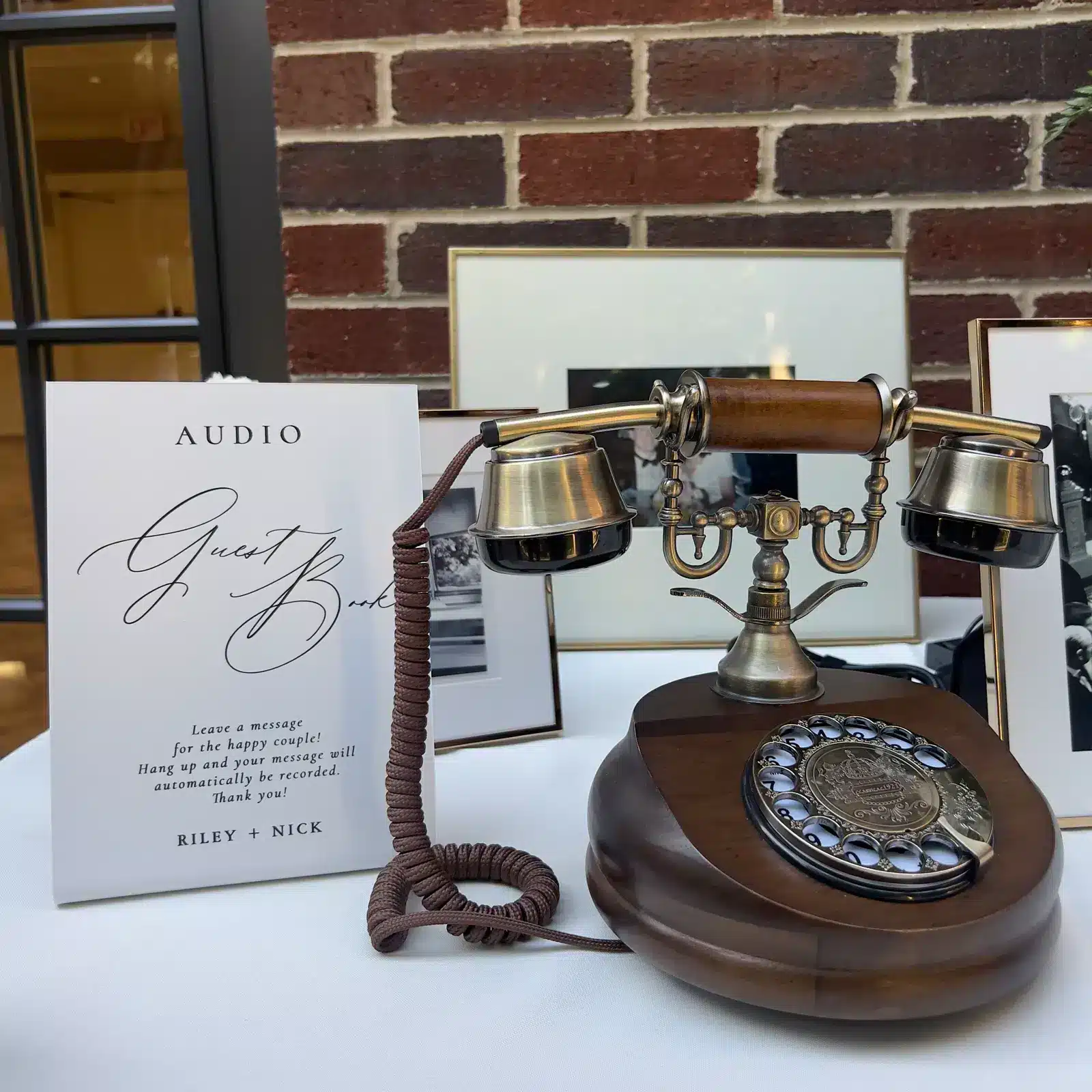 Brass and wood wedding guest book phone beside a message sign